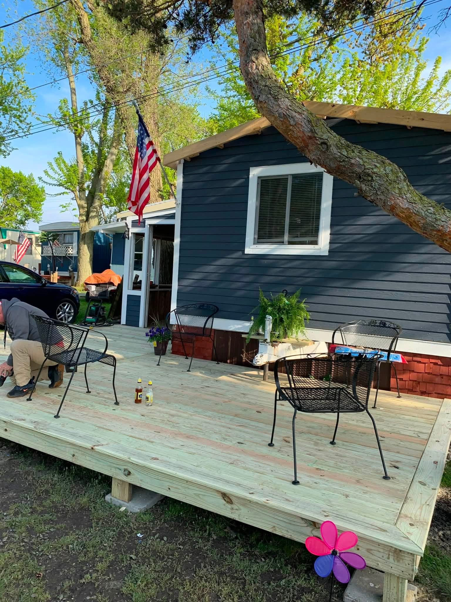 Marine City mobile home after dark siding white trim and new deck work