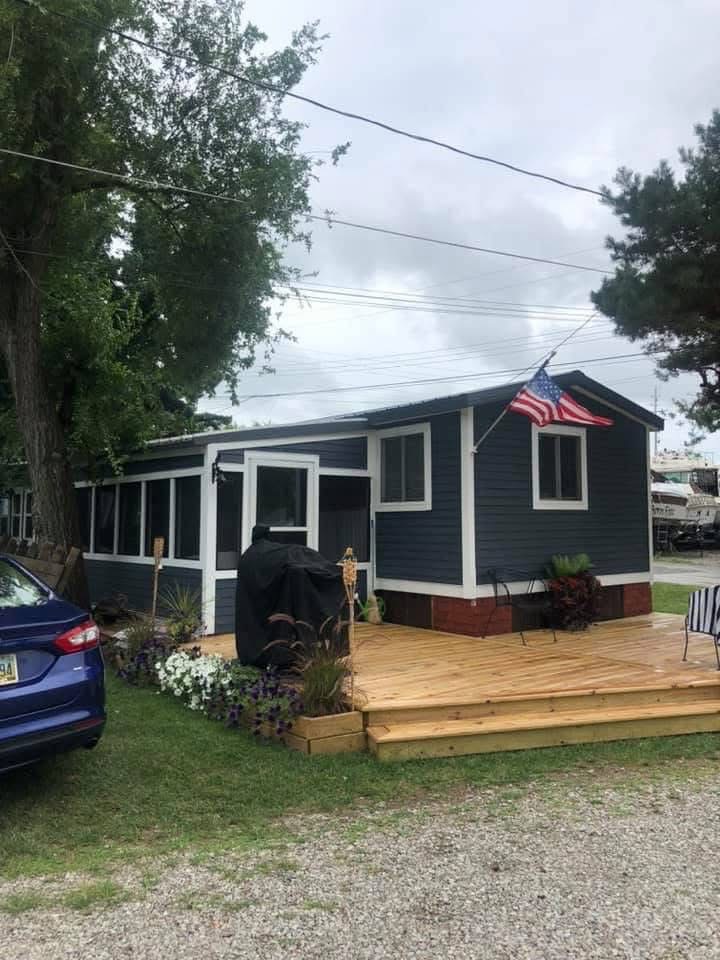 Completed mobile home exterior remodel with deck and outdoor living area near Danbury Township